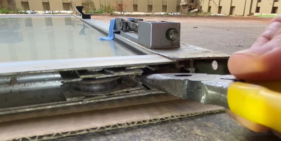 New stainless steel sliding door roller replacement installed on a track wheel assembly