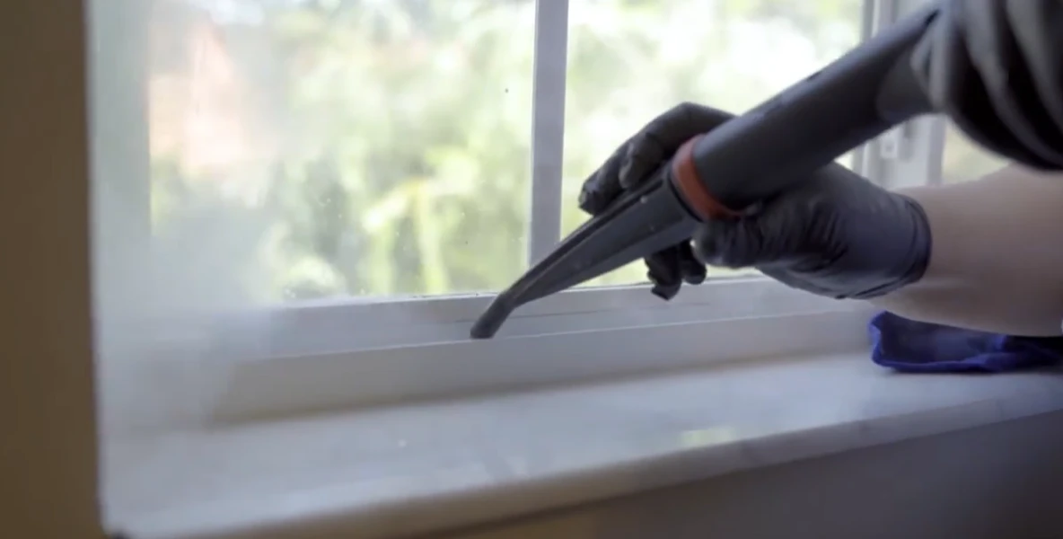 Technician cleaning debris and sand from a sliding glass door track in Fort Myers FL