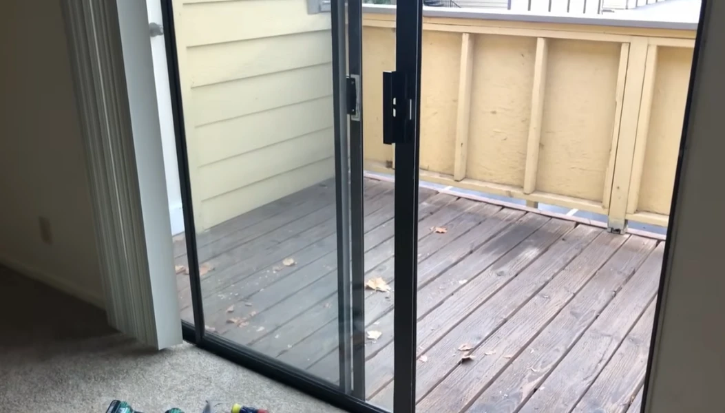Licensed sliding door repair technician servicing a sliding glass door in Fort Myers FL