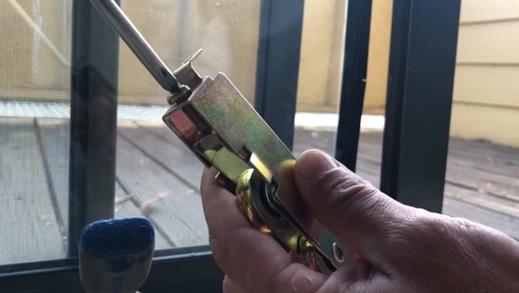 Close-up of sliding door roller repair showing worn wheel assembly in Fort Myers FL