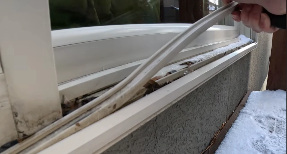 Sliding door track repair in progress showing bent aluminum track being straightened